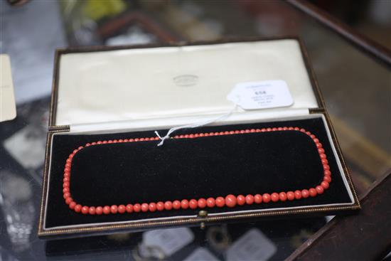 A 1920s single strand graduated coral bead necklace, 47cm.